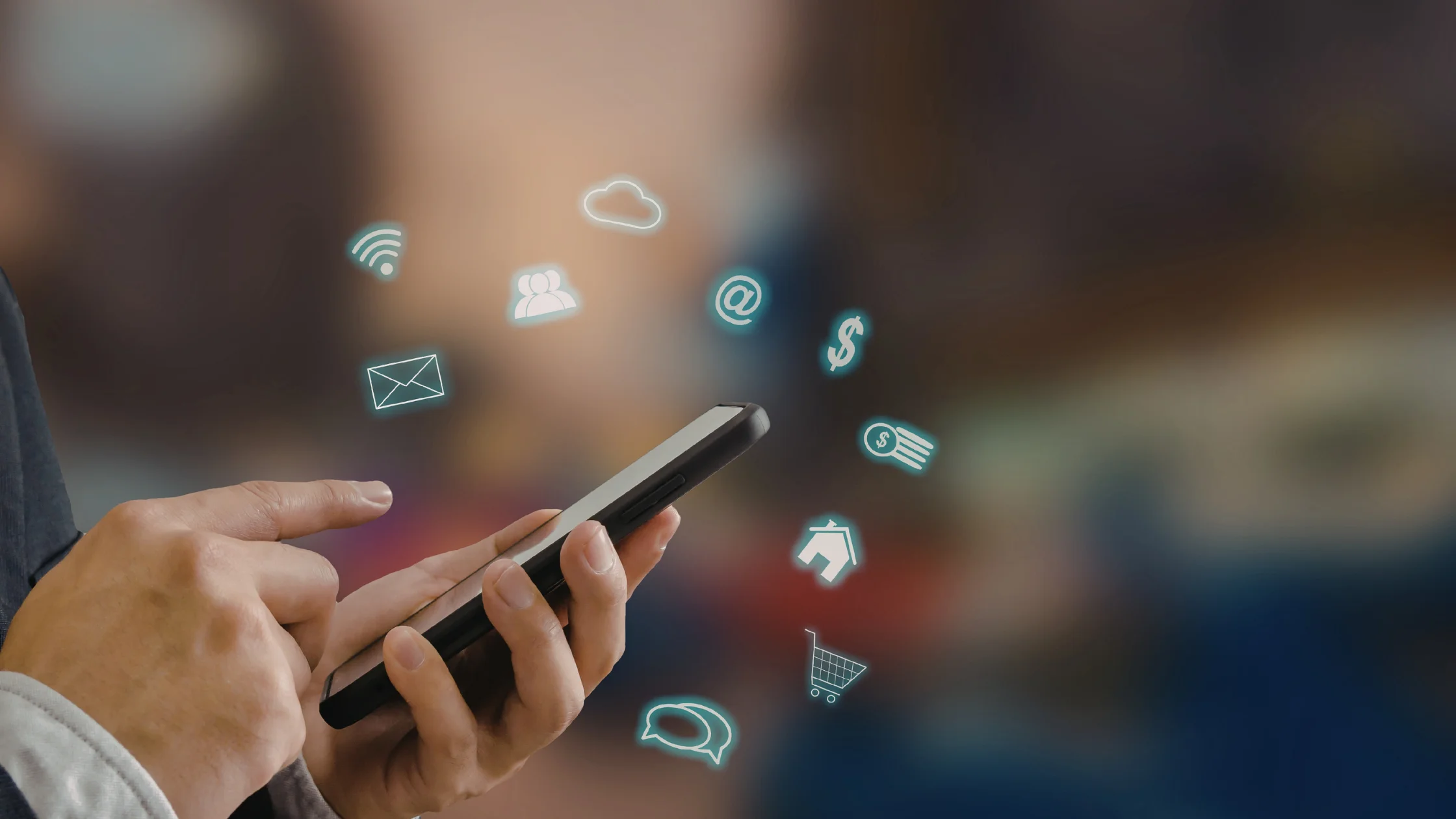 Hände halten ein Smartphone, über dem Symbole für WLAN, E-Mail, Cloud, Nachrichten, Haus, Warenkorb und Geld schweben, als Sinnbild für den Online-Antrag auf Arbeitslosengeld